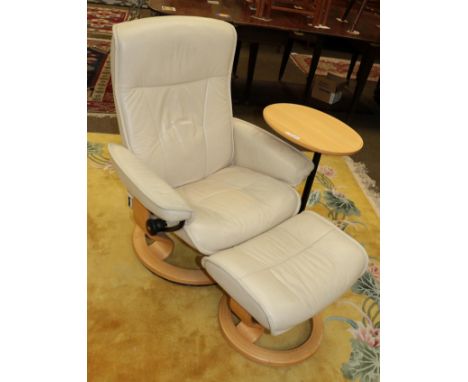 A stressless recliner chair and footstool; together with a matching beech occasional table (3) 