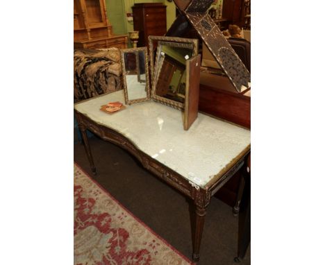 A late 19th century gilt decorated dressing table fitted three frieze drawers, on fluted legs, 137cm wide; and a gilt triptyc