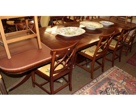 A reproduction mahogany and crossbanded triple pillar dining table, 365cm (extended) by 107cm by 75cm  