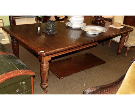 A late Victorian oak extending dining table, with four additional leaves, on turned and reeded legs, 294cm extended 