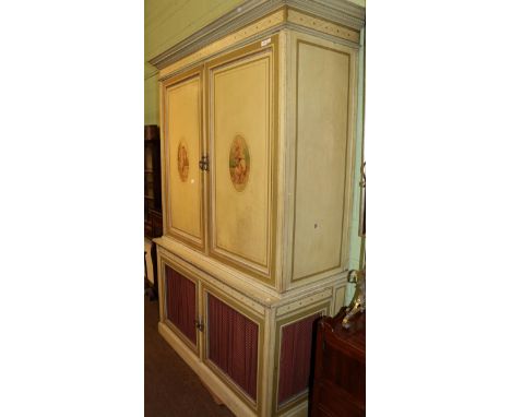 A late 19th/early 20th century wardrobe in the Neoclassical style, with painted oval panel doors, the interior with hanging s