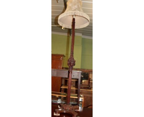 An early 20th century carved mahogany standard lamp and shade