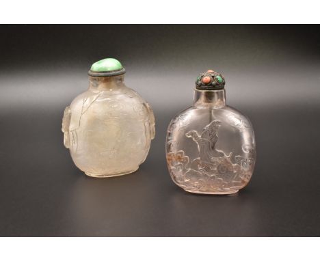TWO LARGE CHINESE ROCK-CRYSTAL CARVED SNUFF BOTTLES, QING DYNASTY, 19TH CENTURY清 高士遊園紋及浮雕觀音 水晶鼻煙壺 两件The first carved with a s