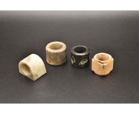 FOUR CHINESE JADE ARCHERS THUMB RINGS, QING DYNASTY OR EARLIER清或更早 玉扳指一組 四隻The stone of various tones of cream and grey (4)Ap