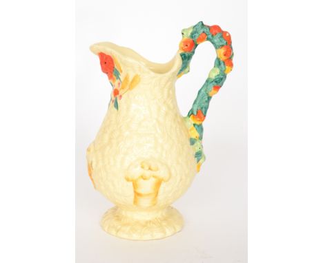 A Clarice Cliff Celtic Harvest pattern jug of footed baluster form relief moulded with corn, fruit and foliage picked out in 
