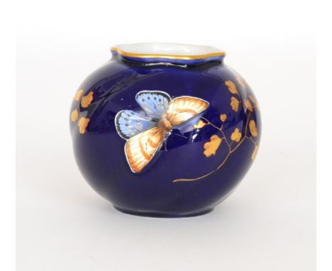 An early 20th Century Royal Worcester cache pot of wrythen form, the dark blue body enamel decorated with a butterflies and m