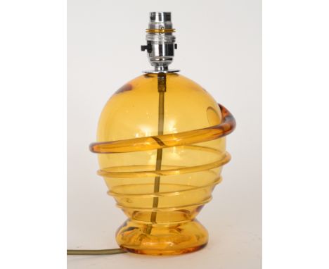 A 1930s Whitefriars table lamp designed by Barnaby Powell of footed spherical form decorated with a golden amber ribbon trail