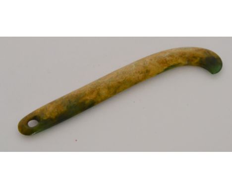 A 20th Century Maori jade or pounamu Kapeu ear pendant or teether, of long elongated shaped rectangular outline with curved f