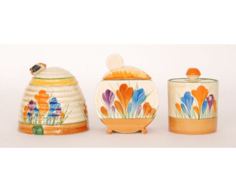 A group of three Clarice Cliff preserve pots to comprise a small Drum shape, a Bon Jour and  Beehive honey pot all hand paint