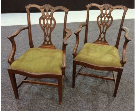 Eight mahogany dining chairs in the Chippendale style, comprising a pair of carver chairs and six side chairs, with drop-in s