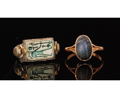 An early 20th Century rose gold coloured scarab beetle ring formed of a carved cabochon blue stone, to forked shoulders, ring