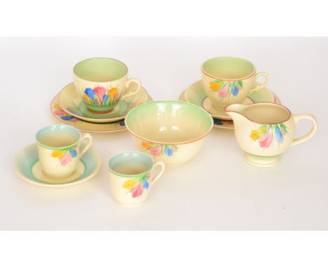 A small assorted collection of Clarice Cliff pottery to include two trios, coffee can, cream jug and sugar bowl all hand pain