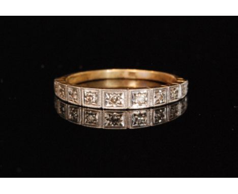 A hallmarked 18ct diamond half eternity ring, the white gold head millegrain set with eleven brilliant cut diamonds, each wit