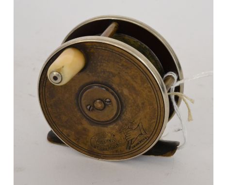 A Hardy brass and half ebonite 2 1/2in reel with rod in hand and oval logos


