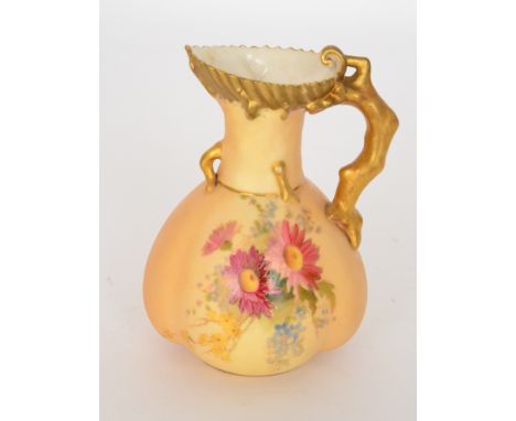 An early 20th Century Royal Worcester blush ivory jug, the body decorated with a spray of flowers, the naturalistic handle fo