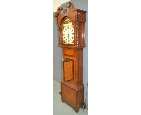 A 19th Century oak and mahogany crossbanded longcase clock the painted arch dial with rural scene incorporating seconds and d