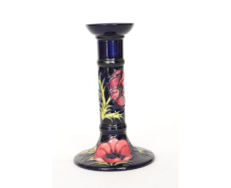 A Moorcroft Pottery single candlestick decorated in the Anemone pattern with tubelined flowers against a blue ground, numbere