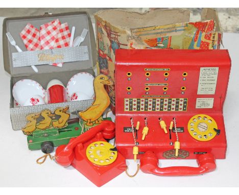 A Codec Toy Town telephone exchange, a Chad Valley pull a long duck and a minirature picnic set.