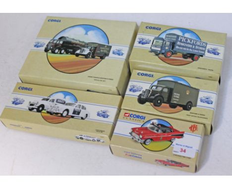 A group of five boxed model Corgi vehicles.