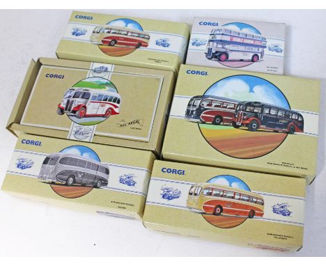 A group of six boxed model Corgi buses.