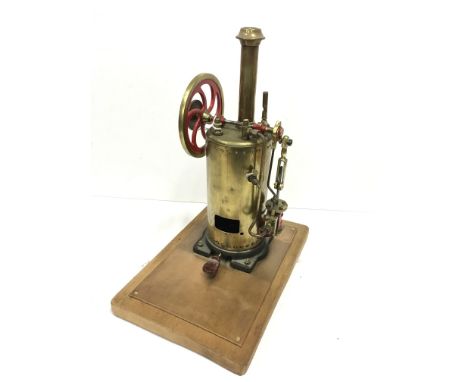 A 12in H Brass Horizontal Steam Engine with a 3in with a single vertical oscillating cylinder with a Brass Base on a wooden p