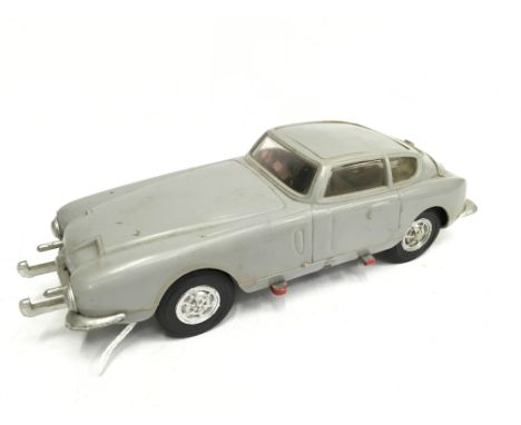 Marx 'Mike Hazard Double Agent' Aston Martin DB5 plastic friction drive model with driver figure, lacks villain. Model in the