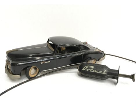 Arnold (Germany) Primal Coupe: tinplate clockwork model in black with driver and lady passenger, manual wind-up remote contro