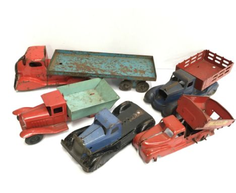 Five pressed steel trucks by Marx, Triang or similar, includes clockwork 'Sand' tipper truck, length 24cm (one wheel missing)