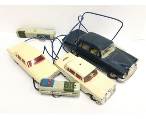 Three Gama (Germany) plastic and tinplate battery operated models with hand-held steering control unit: Mercedes in dark blue