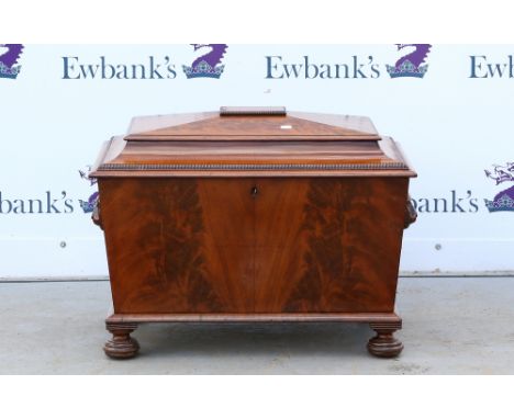 Early 19th century mahogany cellaret with hinged top lacking interior, carved lion head and ring handles on bun feet, 63cm x 