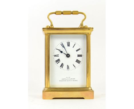 Brass and glass carriage clock with lever escapement, retailed by Haslehurst of Weston Super Mare  .    