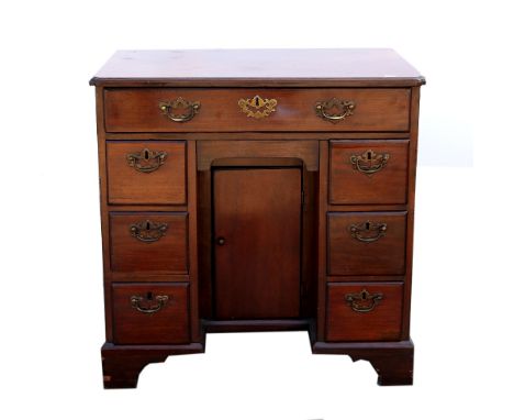 19th century mahogany kneehole desk of seven drawers with cupboard to knee hole, on bracket feet .    