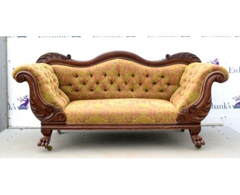 Victorian button back sofa, the mahogany show frame with foliate scrolls, supported on lions' paw feet 85cm High, 183cm Wide,