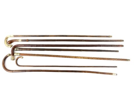 Six 19th century and later gilt mounted walking sticks and canes.    Floral finial: 81cm, Slim cane curved handle: 79cmCane a