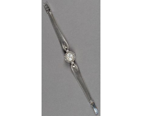 Feine Jaeger-LeCoultre-Damenarmbanduhr, 18 ct. WG. Rundes Gehäuse. Lunette und Anstöße mit ca. 0,50 ct. Brillanten besetzt. A