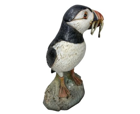 NEIL DALRYMPLE CERAMIC SCULPTURE OF A PUFFIN WITH CATCH - standing on a rocky base, incised signature and date 1994, 31cms H