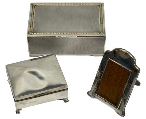 SILVER CIGARETTE BOXES (2) and a small easel back photograph frame, London 1927 the larger box, Maker Walker &amp; Hall, engi