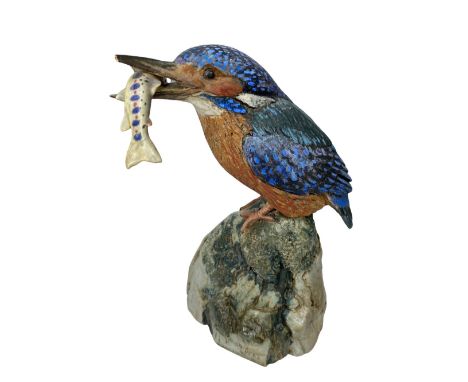 NEIL DALRYMPLE CERAMIC SCULPTURE OF A KINGFISHER WITH CATCH - standing on a rocky mount, incised signature and date 1993, 22c