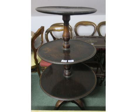 A GEORGIAN MAHOGANY THREE TIER GRADUATED DUMB WAITER each circular dish joined by a baluster support on tripod base 120cm x 6