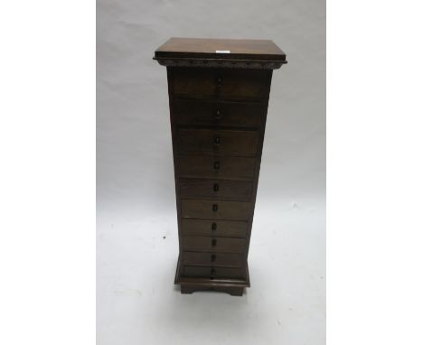 A TEAK CHEST OF TEN DRAWERS, on bracket feet,112cms x 36cms x 29cms.