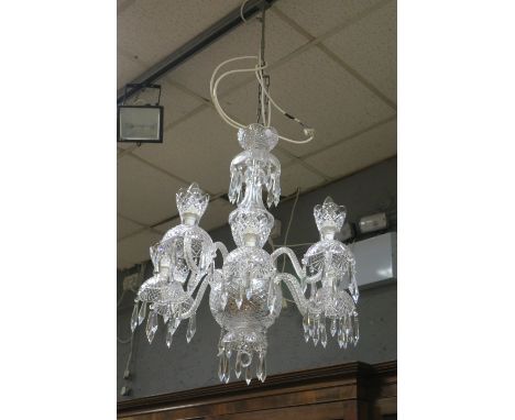 AN EIGHT ARM CUT GLASS TARA CRYSTAL CHANDELIER with scrolled arms foliate cut drip pans hung with pendant drops