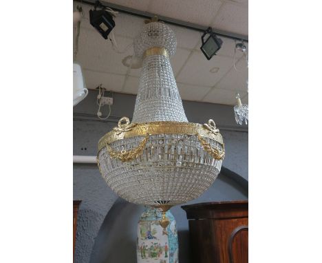 A LARGE CONTINENTAL CUT GLASS AND GILT BRASS CHANDELIER, with facetted pendants, 175cms drop.