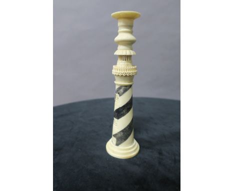 A SIMULATED IVORY CANDLESTICK, modelled as a lighthouse,