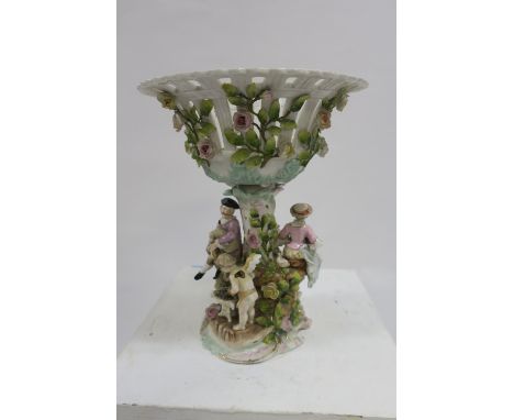A CONTINENTAL GLAZED PORCELAIN CENTREPIECE the circular pierced bowl applied with painted flower heads supported by a stylise