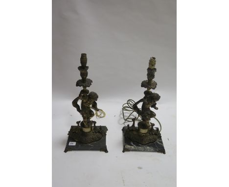 A PAIR OF GILT BRASS TABLE LAMPS modelled as seated amorini on a classical pillar with a rectangular marble plinth  54cm high