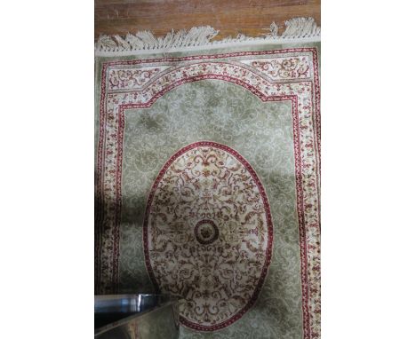 A WOOL RUNNER, the light green and beige ground with central oval panels within a conforming border,398cms x 80cms