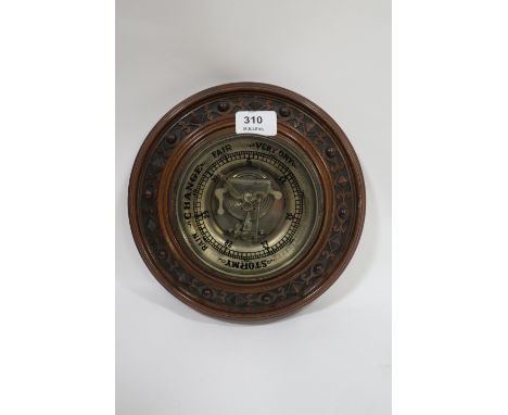 A 19th CENTURY MAHOGANY FRAMED WALL MOUNTED BAROMETER of circular form the moulded frame carved with strapwork with clear gla