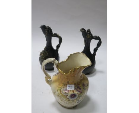 A PAIR OF BLACK PAINTED POTTERY VASES of circular tapering form with stylised rope twist handles decorated with foliates toge