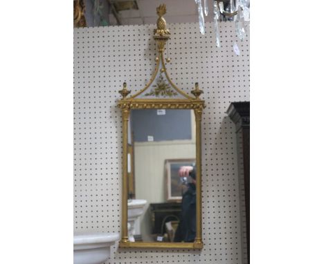 A REGENCY STYLE GILTWOOD MIRROR, the rectangular plate between reeded half pilasters with corinthian capitals and ball decora