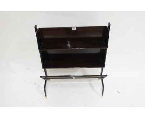 AN ITALIAN ROSEWOOD MAGAZINE RACK c. 1950 the rectangular open shelves between shaped side supports with a further sloping sh